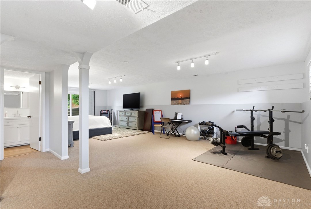 8916 Paragon Road Dayton, OH 45458 - Photo 24 of 33 This versatile basement offers ample space for a home gym and a cozy bedroom retreat.