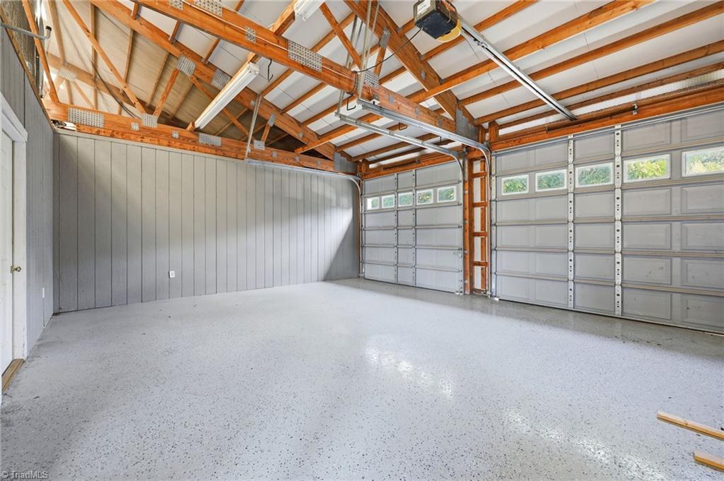 8861 Boylston Road Colfax, NC 27235 - Photo 49 of 50 The barn also features a spacious two-car garage with durable epoxy floors—perfect for vehicles, trailers, tractors, or additional equipment storage.
