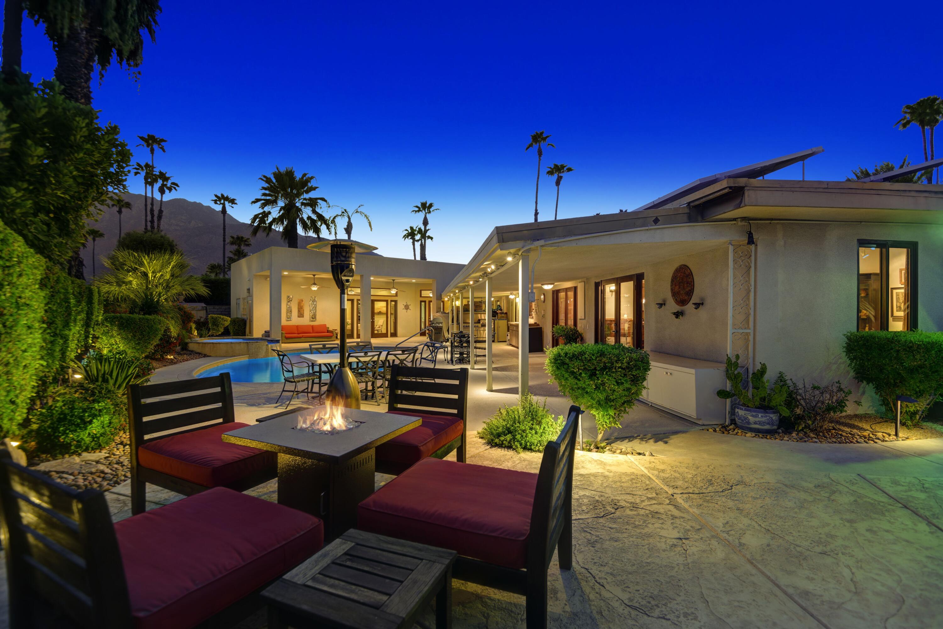 a view of a house with backyard and sitting area