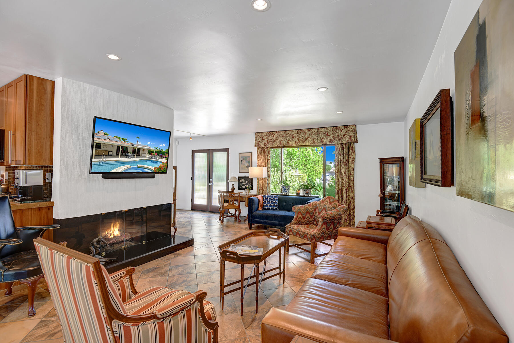 2915 Guadalupe Road Palm Springs, CA 92264 - Photo 15 of 52 a living room with furniture a flat screen tv and a fireplace