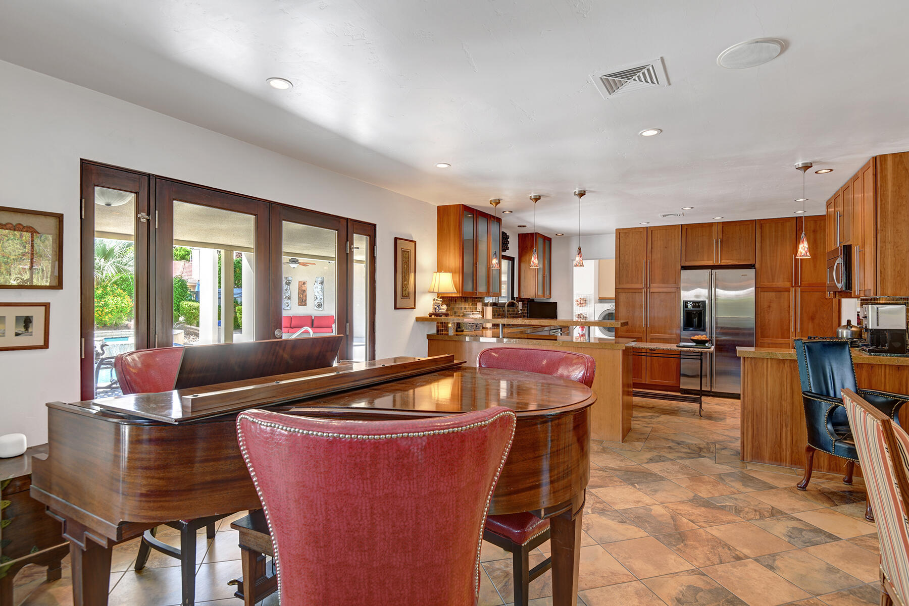 2915 Guadalupe Road Palm Springs, CA 92264 - Photo 19 of 52 a dining room with stainless steel appliances kitchen island granite countertop a dining table chairs and a refrigerator