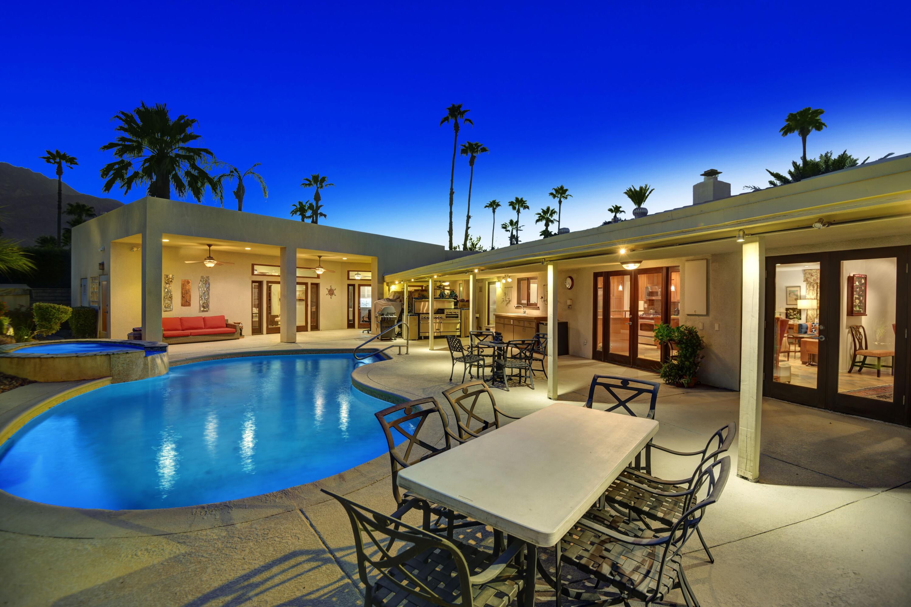 2915 Guadalupe Road Palm Springs, CA 92264 - Photo 3 of 52 a view of a dining room with furniture a chandelier and wooden floor