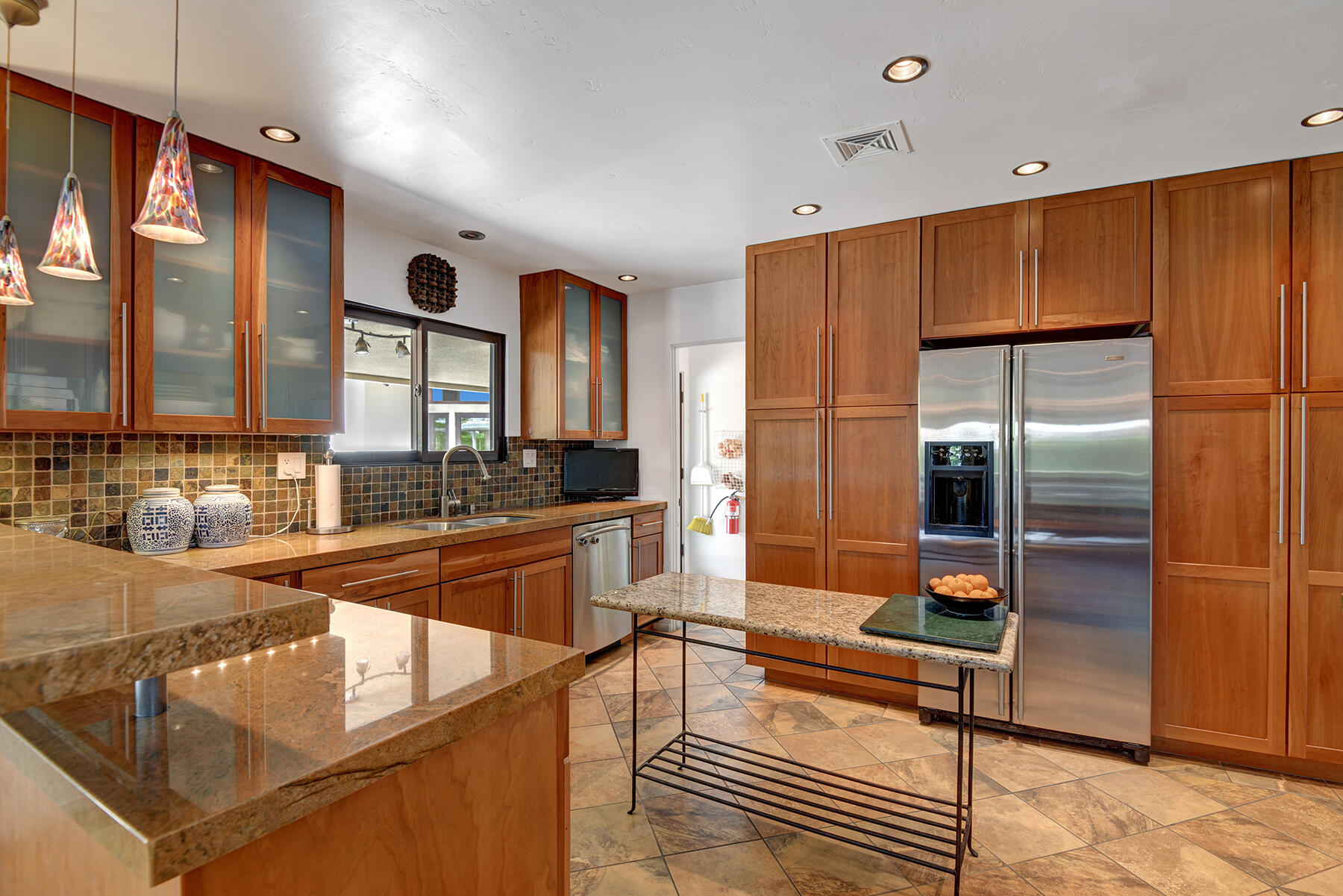 2915 Guadalupe Road Palm Springs, CA 92264 - Photo 21 of 52 a kitchen with stainless steel appliances granite countertop a refrigerator and a sink