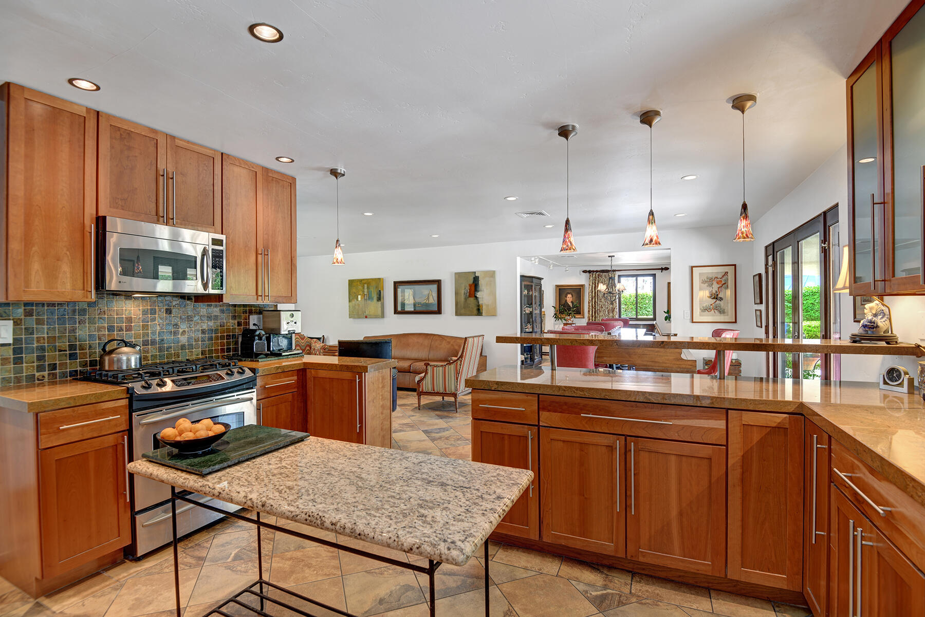 2915 Guadalupe Road Palm Springs, CA 92264 - Photo 23 of 52 a kitchen with stainless steel appliances kitchen island granite countertop a sink and cabinets