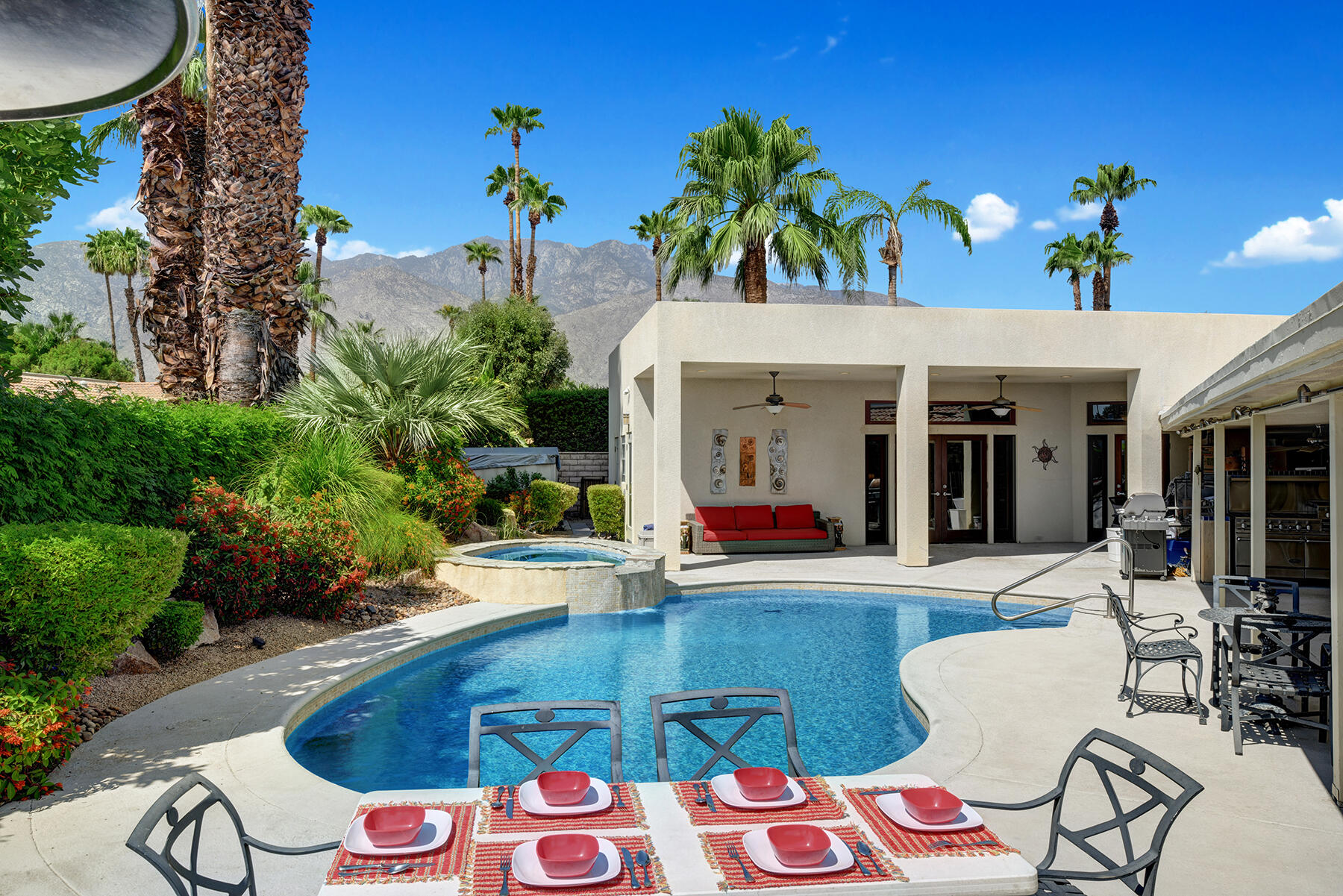2915 Guadalupe Road Palm Springs, CA 92264 - Photo 25 of 52 a view of a patio with table and chairs potted plants