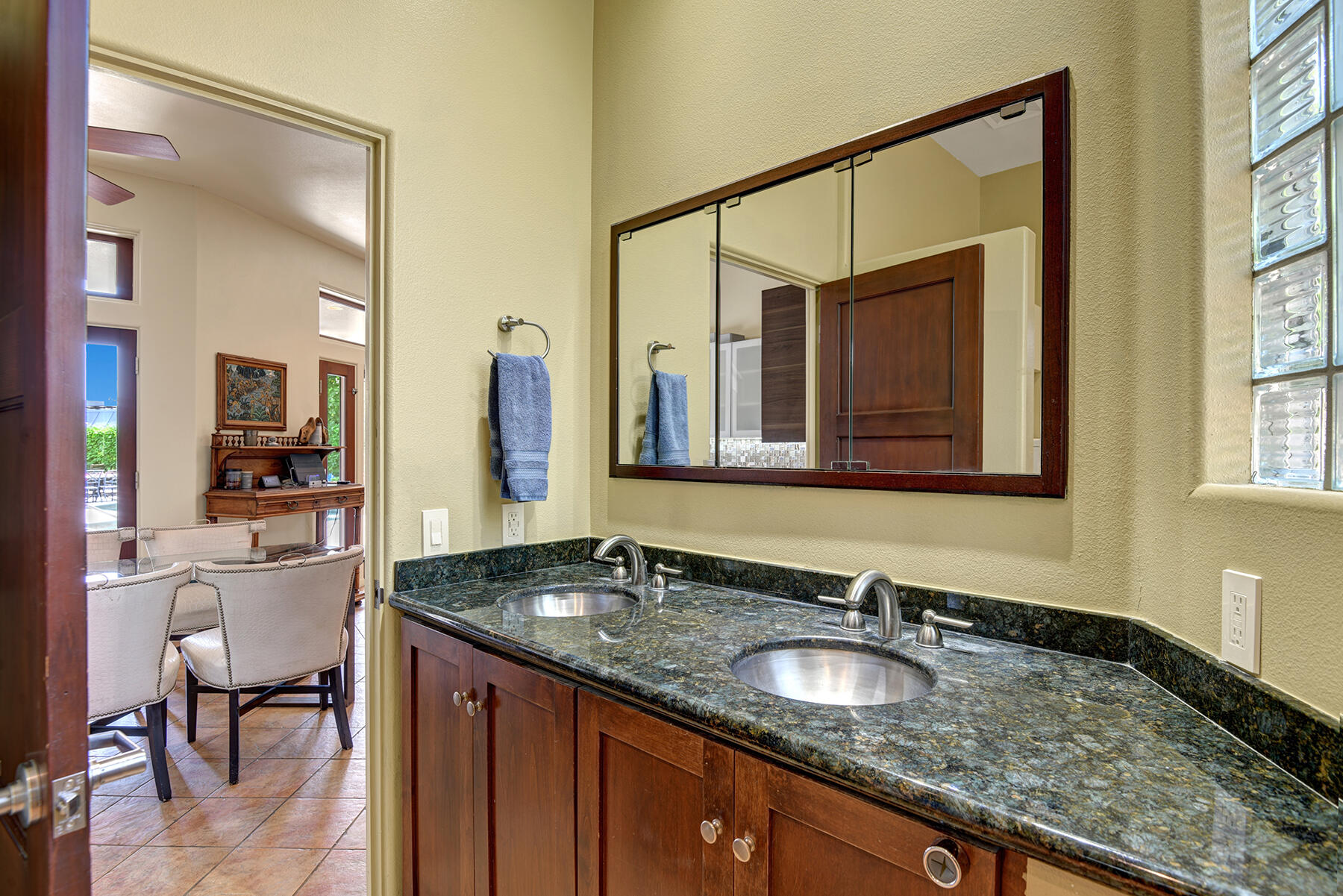 2915 Guadalupe Road Palm Springs, CA 92264 - Photo 50 of 52 a bathroom with a granite countertop sink and a mirror