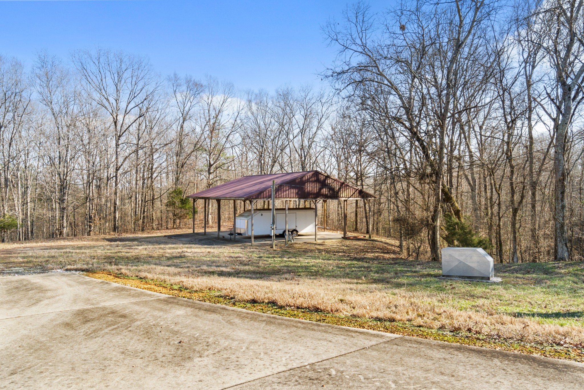 1760 Point Pleasant Road Buchanan, TN 38222 - Photo 18 of 50 a backyard of a house with trees and houses