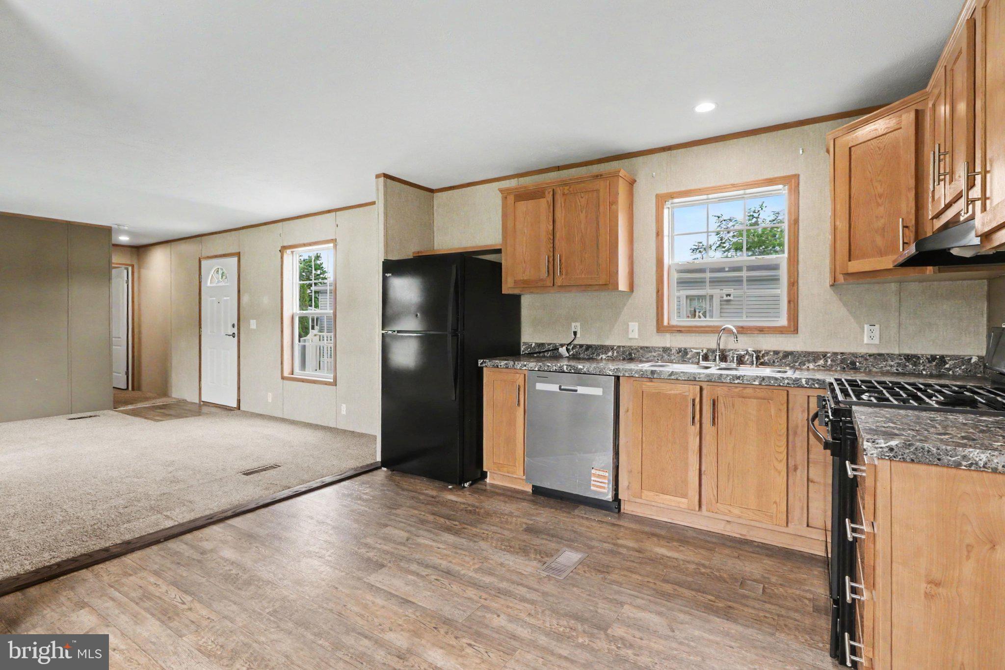 66 Kip Road Halifax, PA 17032 - Photo 6 of 16 a kitchen with granite countertop a refrigerator stove top oven and sink