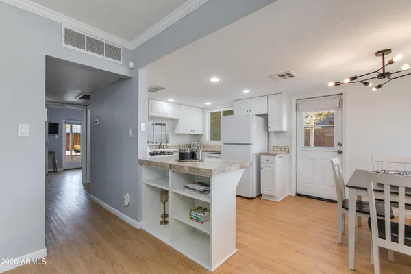 a backyard of a house with table and chairs