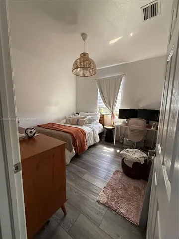 a bedroom with bed and window