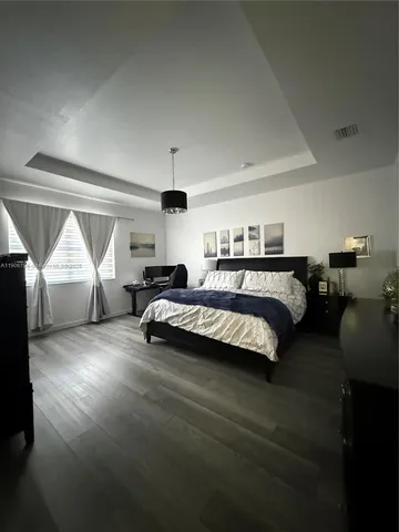 a bedroom with furniture and a lamp