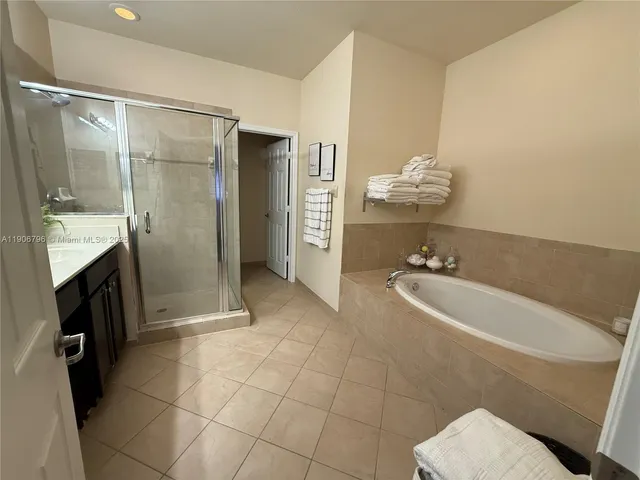 a bathroom with a tub sink and mirror