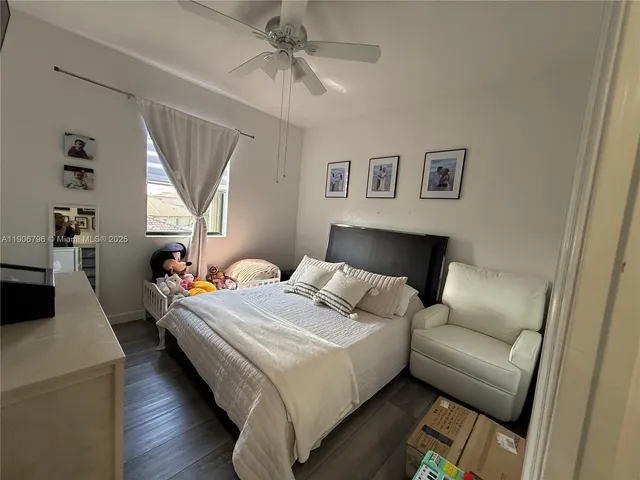 a bedroom with a bed couch and a window