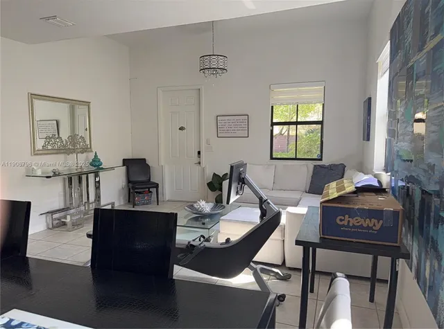 a living room with furniture a piano and a window
