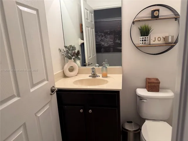 a bathroom with a toilet a sink and a mirror