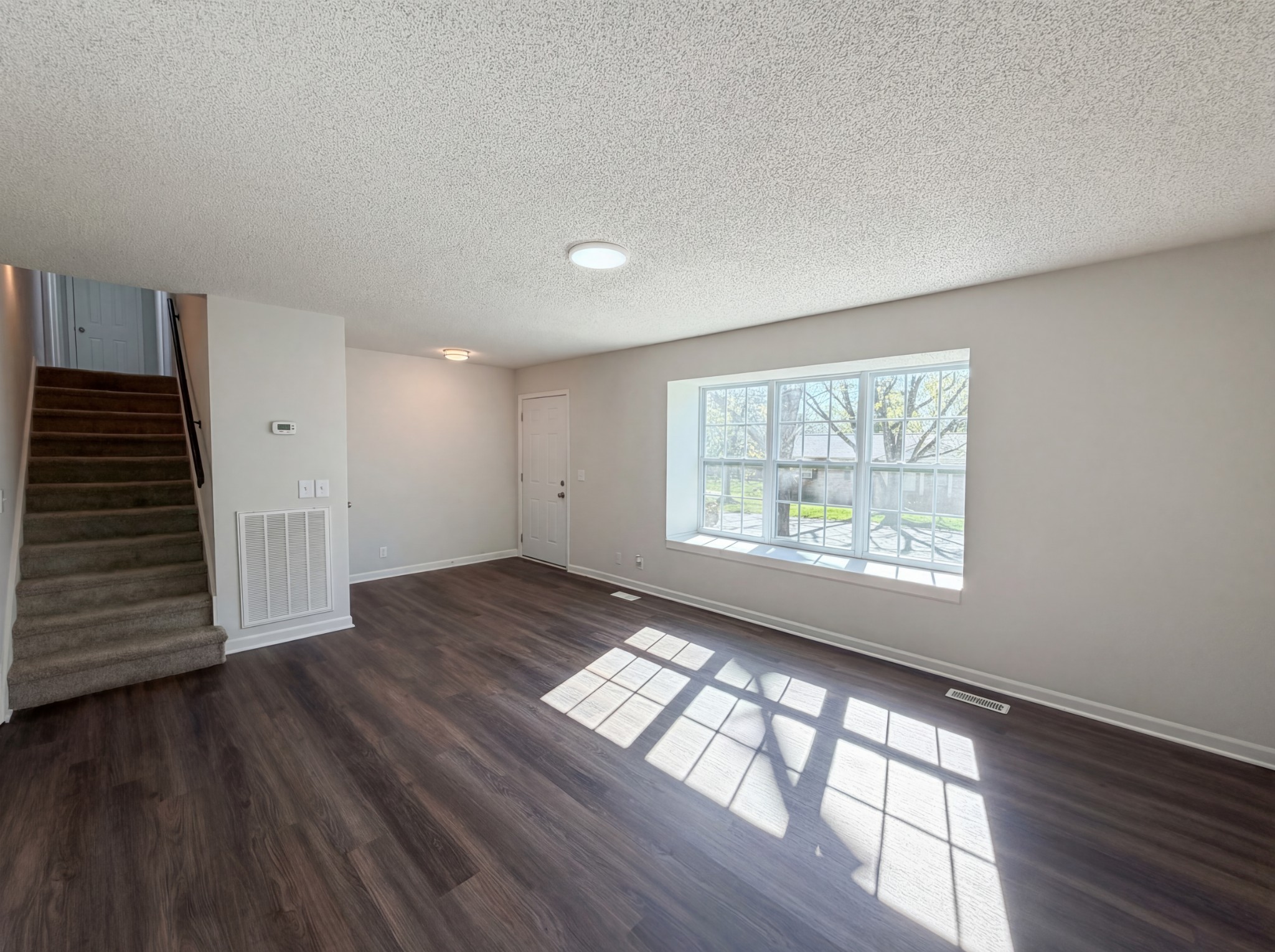 5148 Roxborough Drive Hermitage, TN 37076 - Photo 3 of 19 a view of an empty room with wooden floor and a window