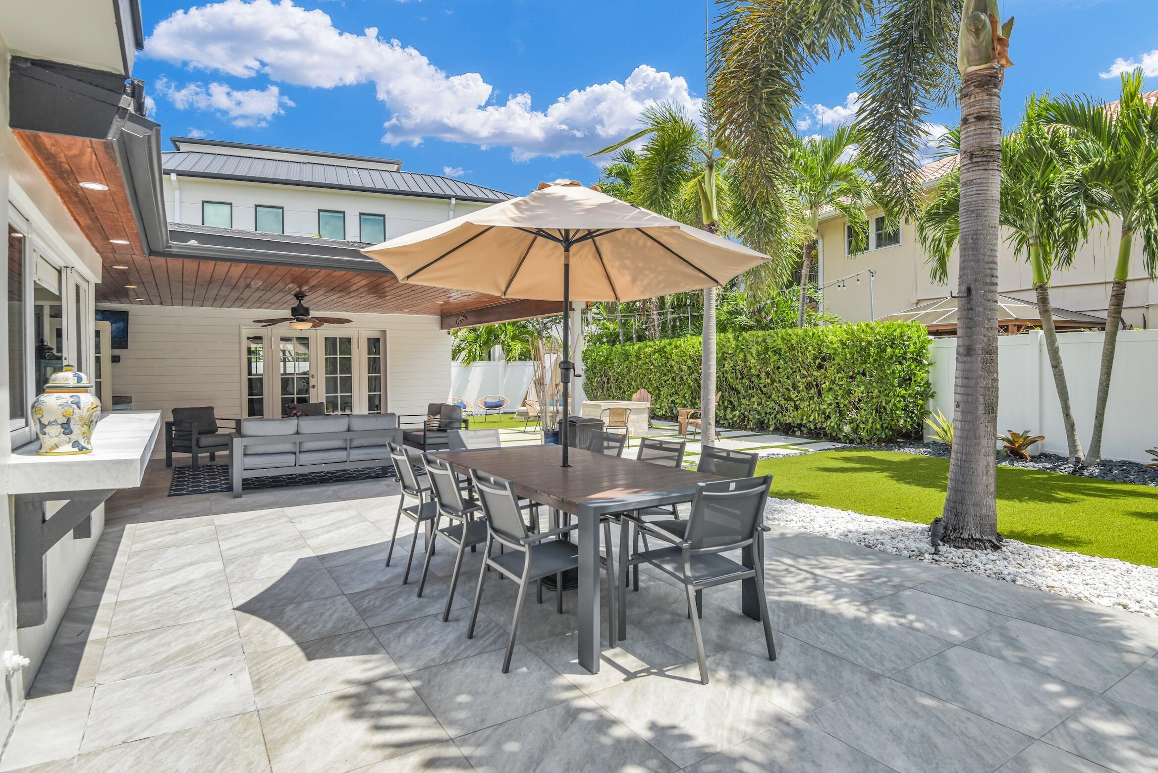 701 Appleby Street Boca Raton, FL 33487 - Photo 21 of 47 a view of a patio with a table and chairs under an umbrella