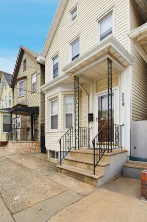 a view of a room with wooden floor and a ceiling fan