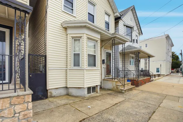 a kitchen with a sink a refrigerator and cabinets
