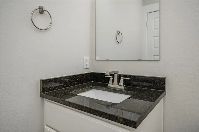a sink sitting inside of a granite counter top