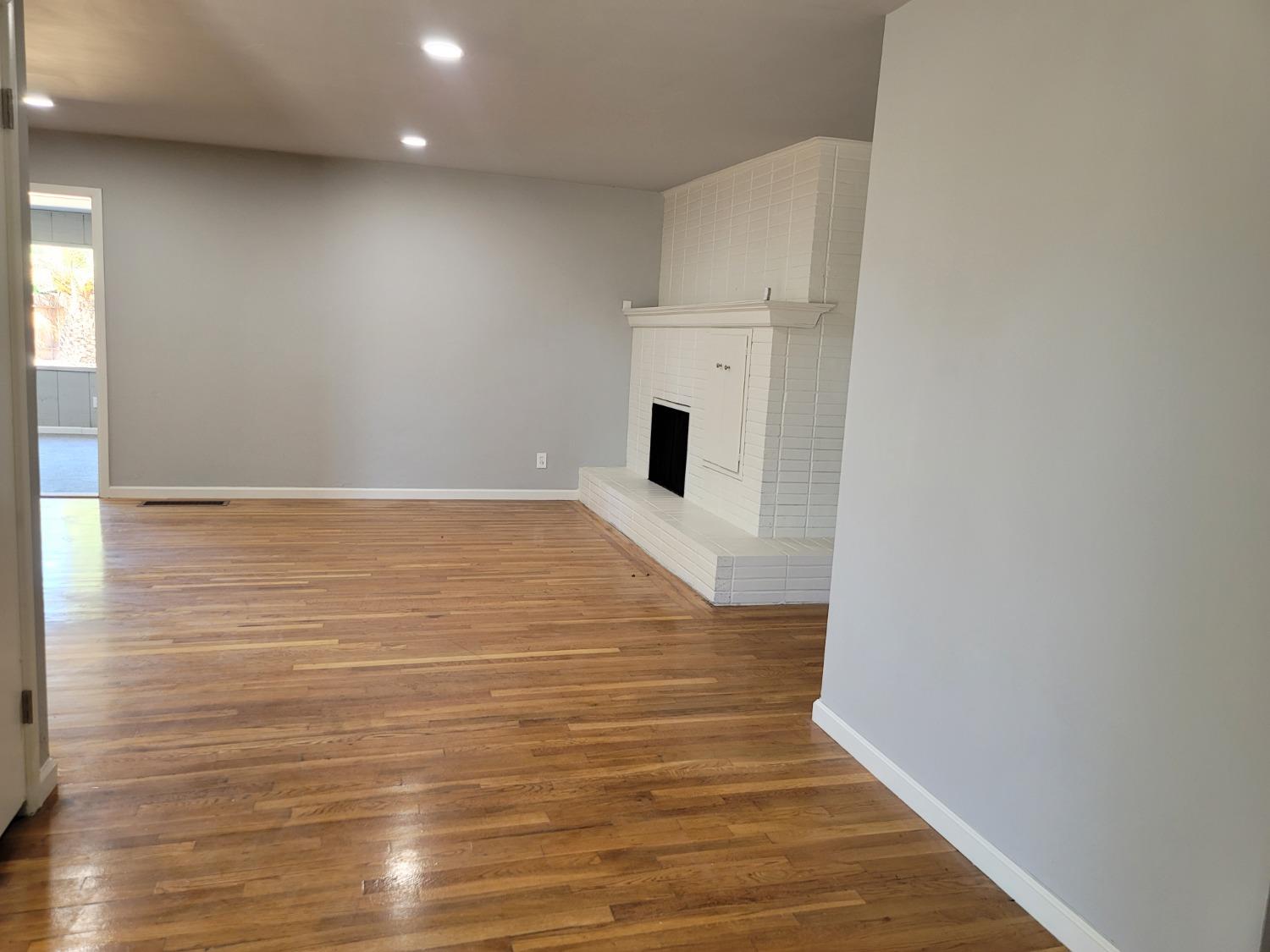 522 Willis Avenue Madera, CA 93637 - Photo 12 of 40 a view of empty room with wooden floor
