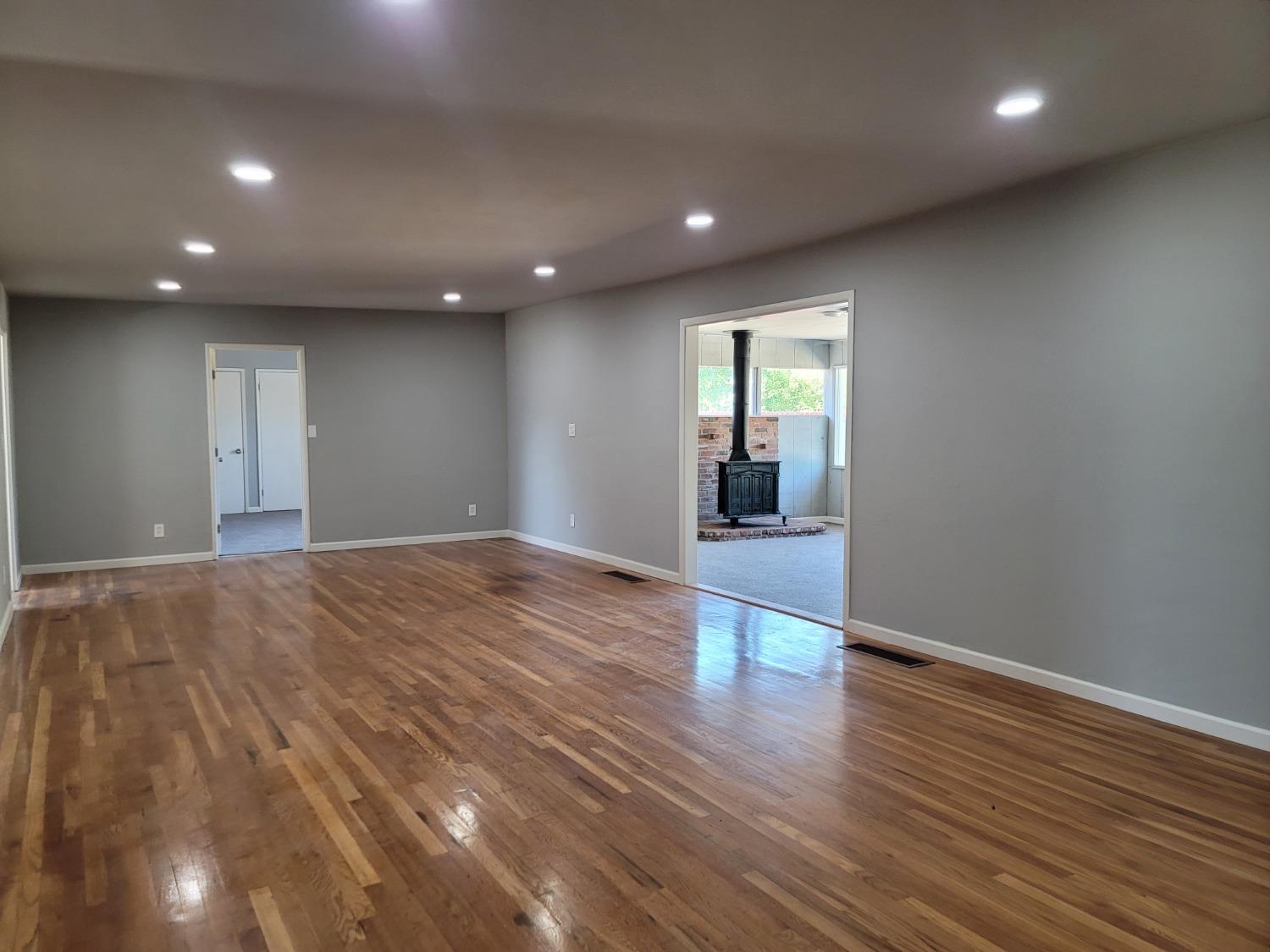 522 Willis Avenue Madera, CA 93637 - Photo 13 of 40 an empty room with wooden floor and windows