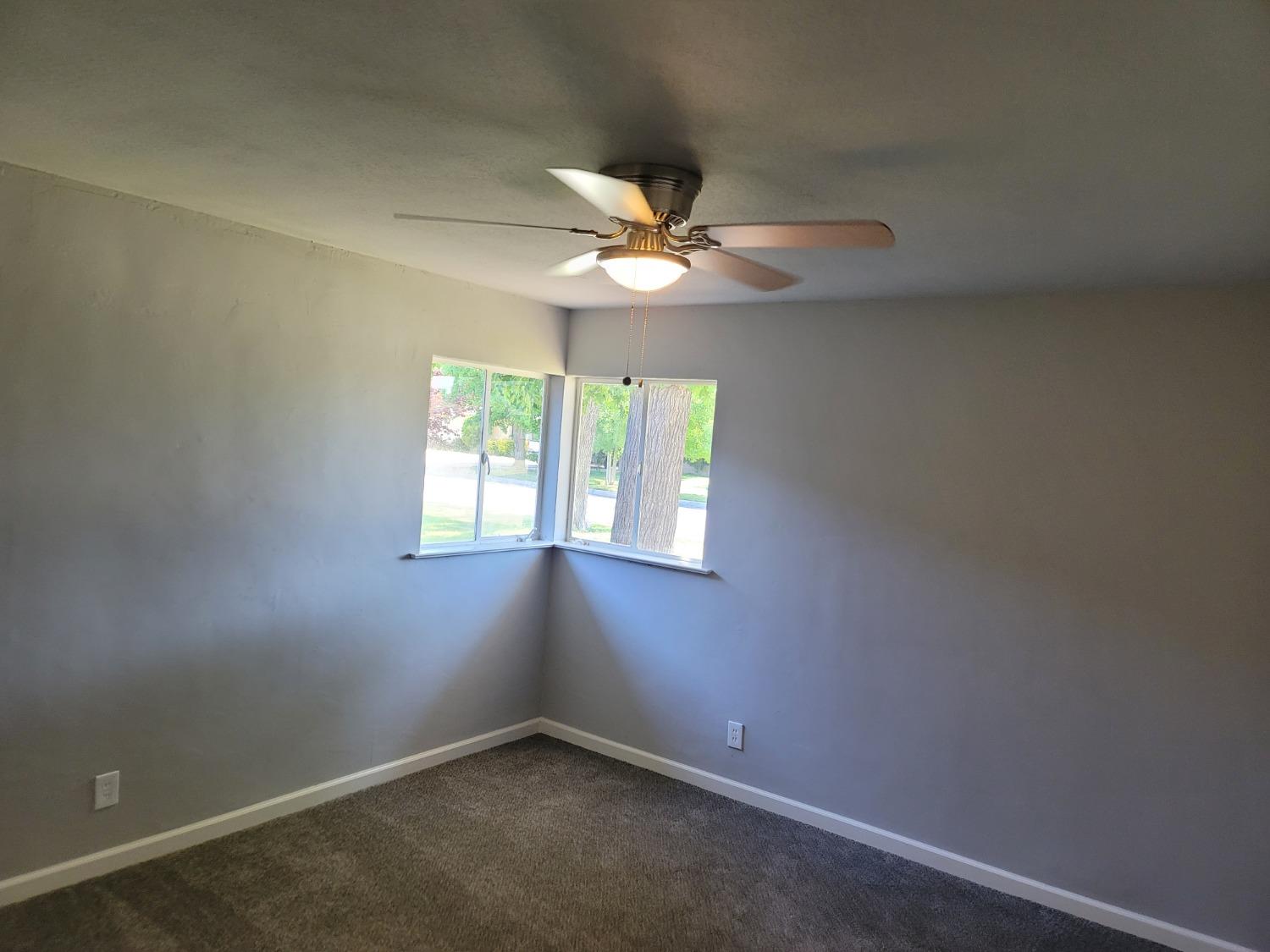 522 Willis Avenue Madera, CA 93637 - Photo 23 of 40 an empty room with a window and a fan