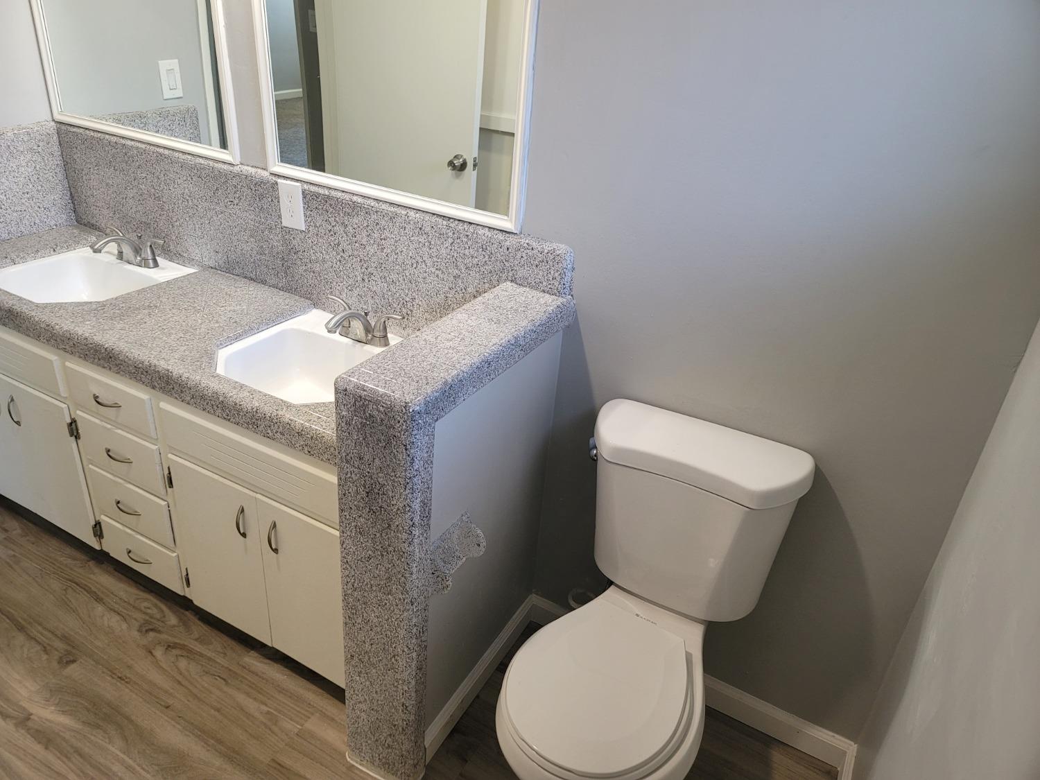 522 Willis Avenue Madera, CA 93637 - Photo 27 of 40 a white toilet sitting next to a bathroom sink