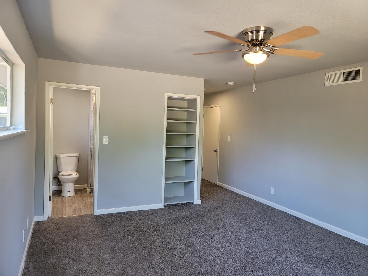 522 Willis Avenue Madera, CA 93637 - Photo 30 of 40 wooden floor in an empty room and a bathroom