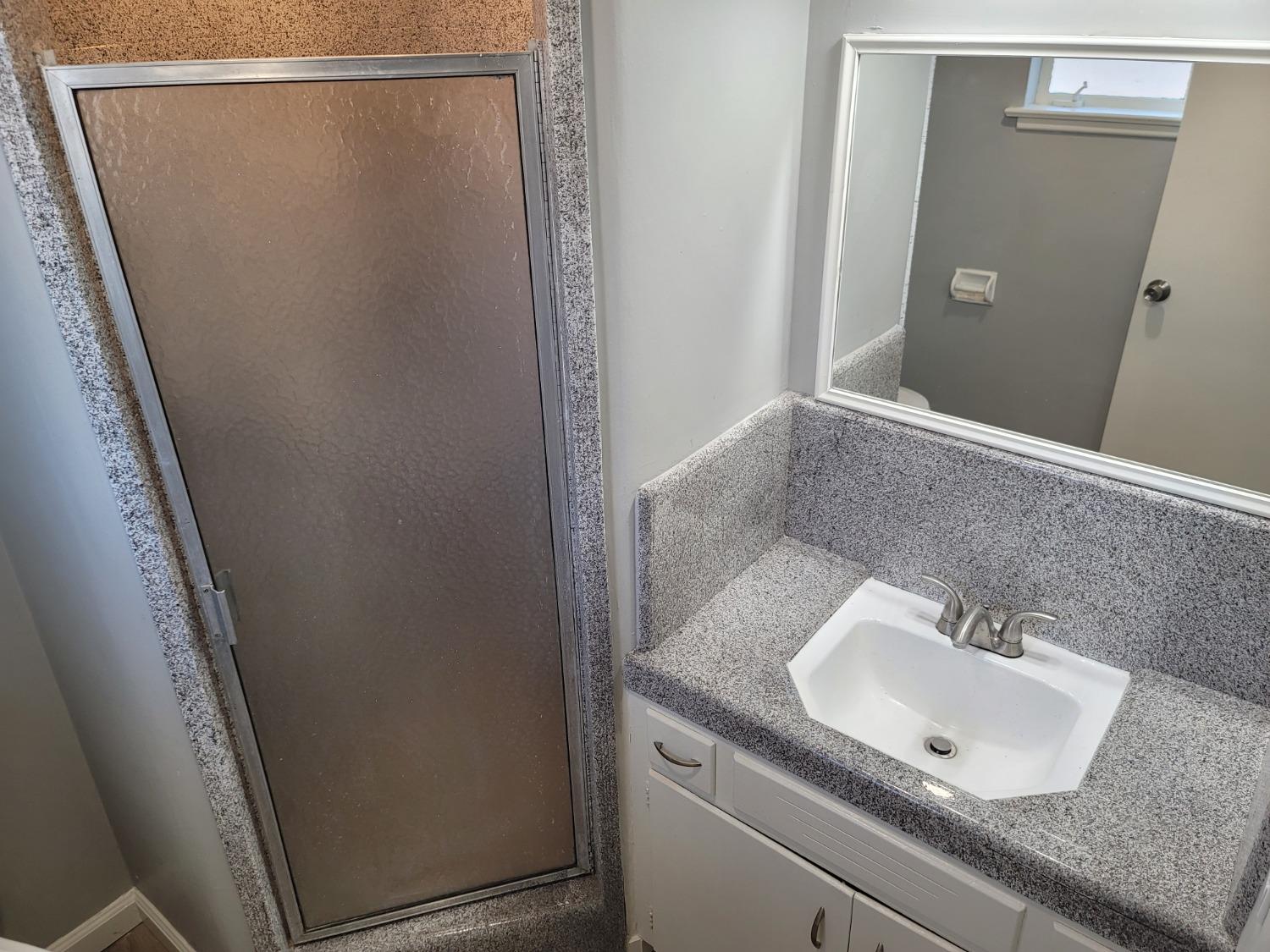 522 Willis Avenue Madera, CA 93637 - Photo 32 of 40 a bathroom with a sink and a mirror