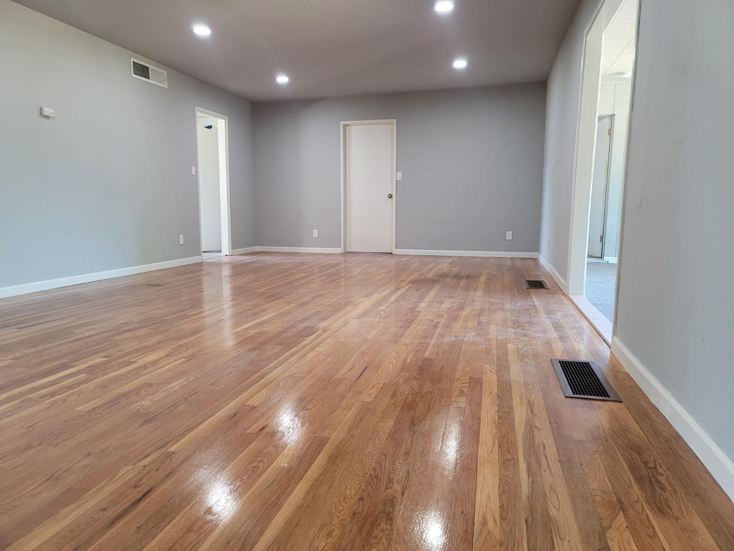 522 Willis Avenue Madera, CA 93637 - Photo 33 of 40 an empty room with wooden floor and windows