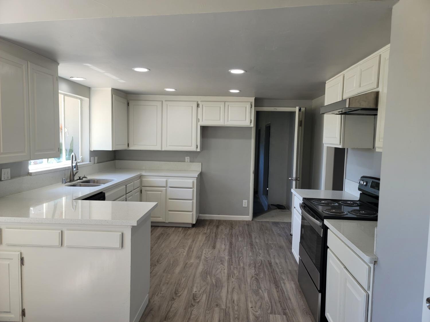 522 Willis Avenue Madera, CA 93637 - Photo 6 of 40 a kitchen with a refrigerator and a sink