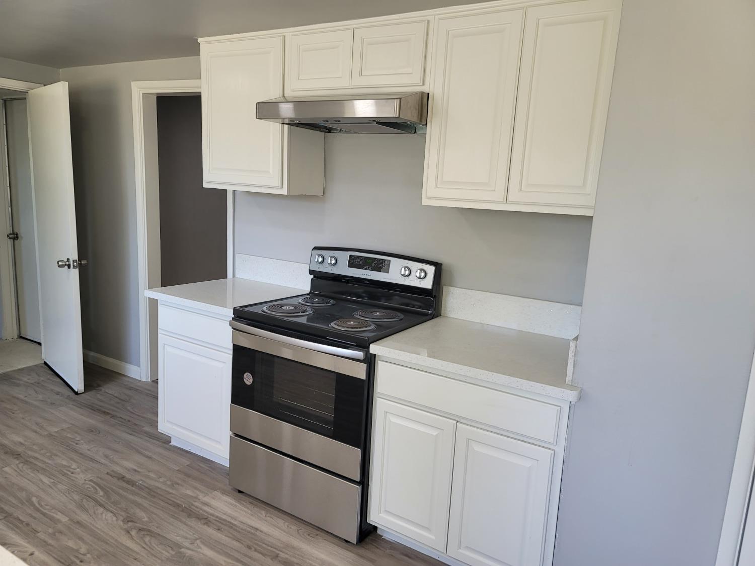522 Willis Avenue Madera, CA 93637 - Photo 7 of 40 a white stove top oven sitting inside of a kitchen