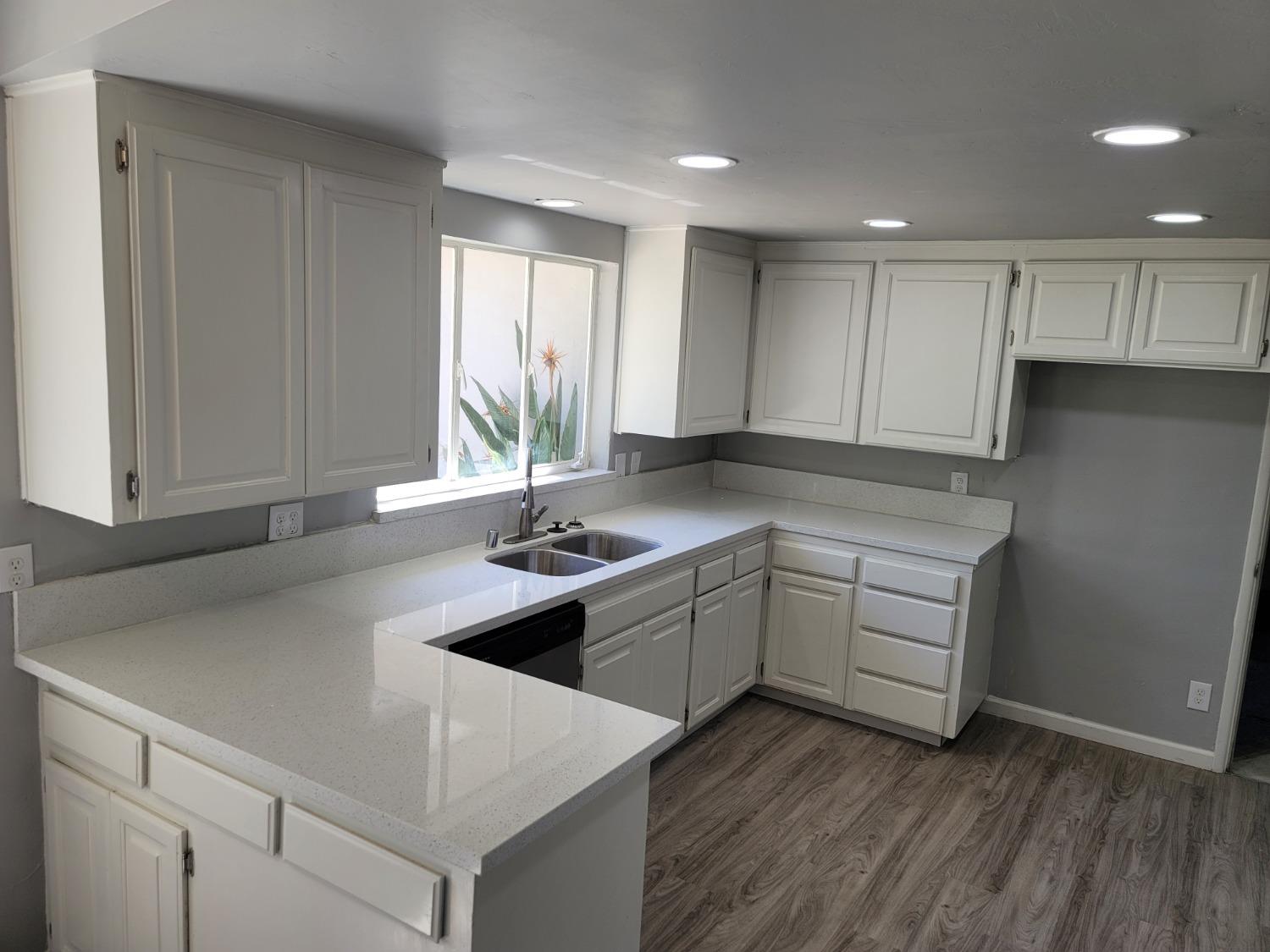 522 Willis Avenue Madera, CA 93637 - Photo 8 of 40 a kitchen with a sink window and cabinets
