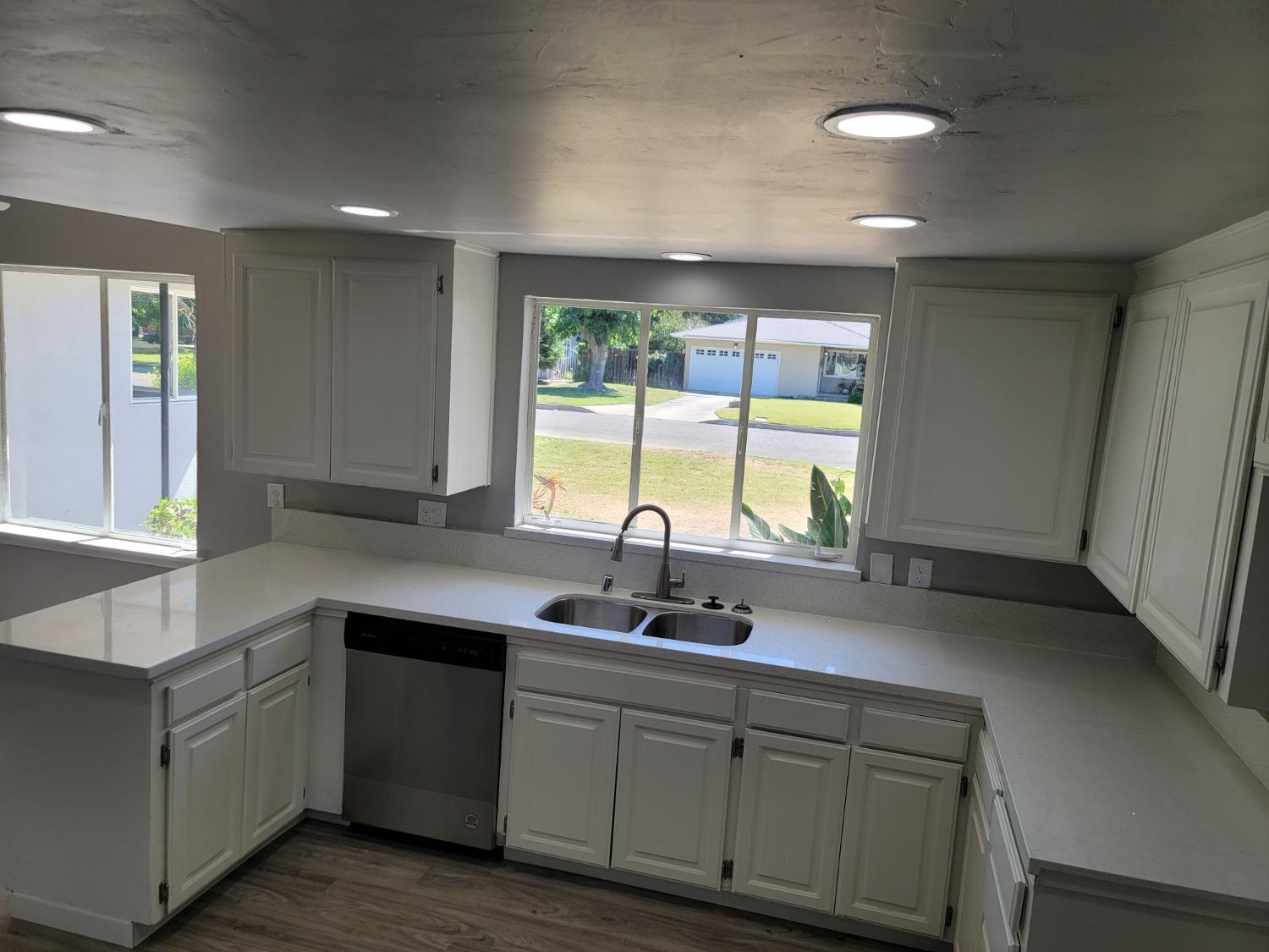 522 Willis Avenue Madera, CA 93637 - Photo 9 of 40 a kitchen with sink a window and cabinets
