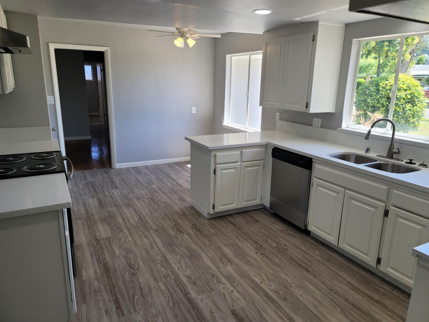 522 Willis Avenue Madera, CA 93637 - Photo 10 of 40 a kitchen with granite countertop a sink cabinets and wooden floor