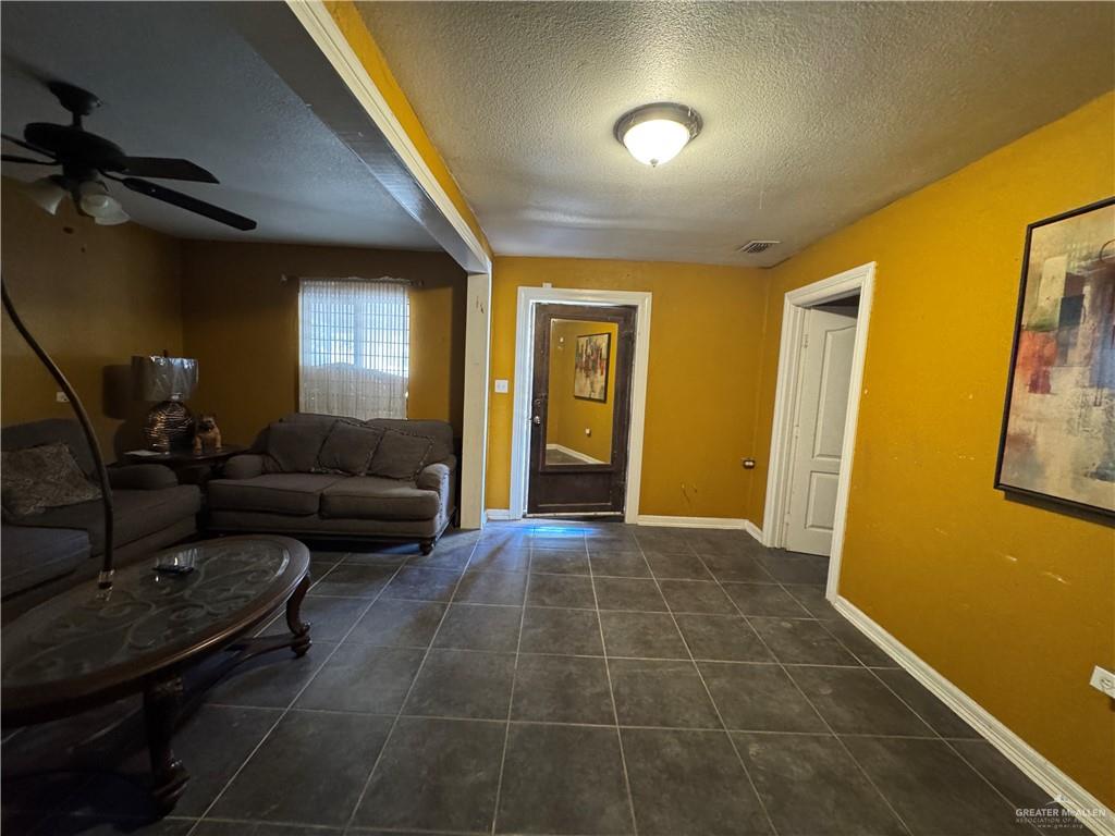 3757 Tom Gill Road Penitas, TX 78576 - Photo 2 of 12 a living room with furniture and a flat screen tv