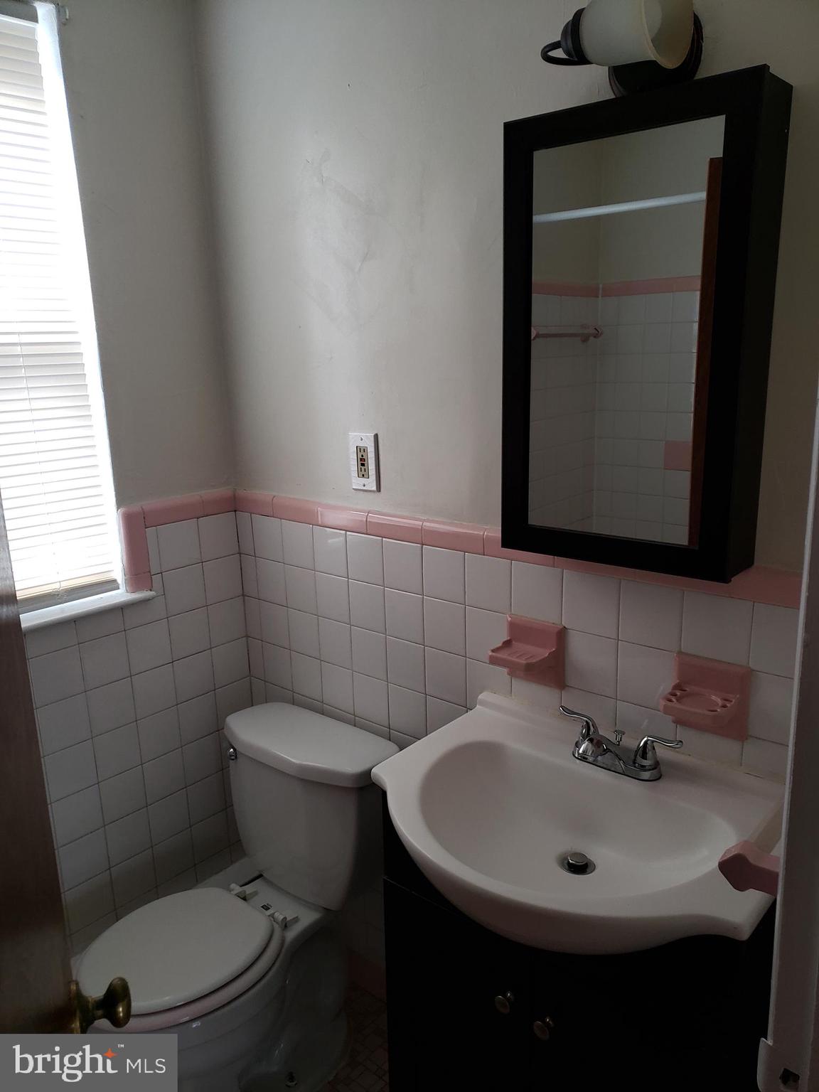 737-39 Borbeck Avenue, Unit D Philadelphia, PA 19111 - Photo 14 of 17 a bathroom with a sink a toilet and a mirror