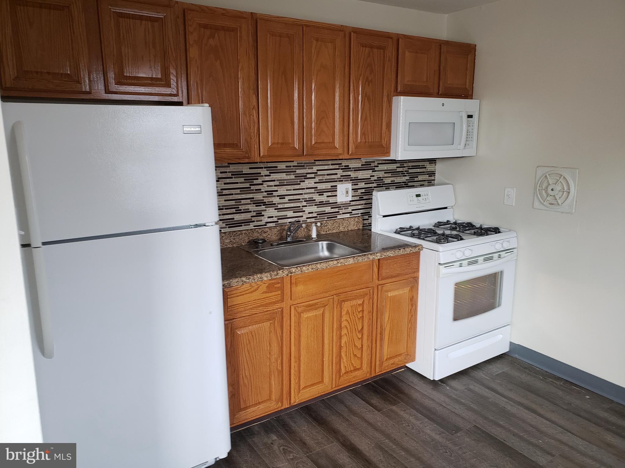 737-39 Borbeck Avenue, Unit D Philadelphia, PA 19111 - Photo 9 of 17 a kitchen with stainless steel appliances a stove a microwave and a refrigerator