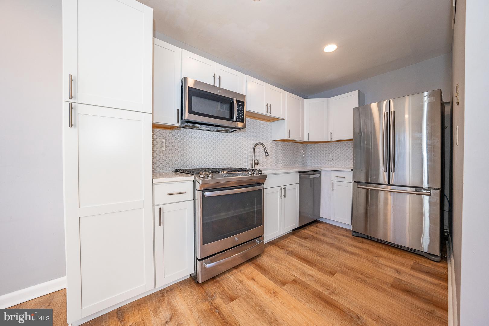 601 Briarcliff Road Upper Darby, PA 19082 - Photo 19 of 63 a kitchen with stainless steel appliances a refrigerator stove and microwave