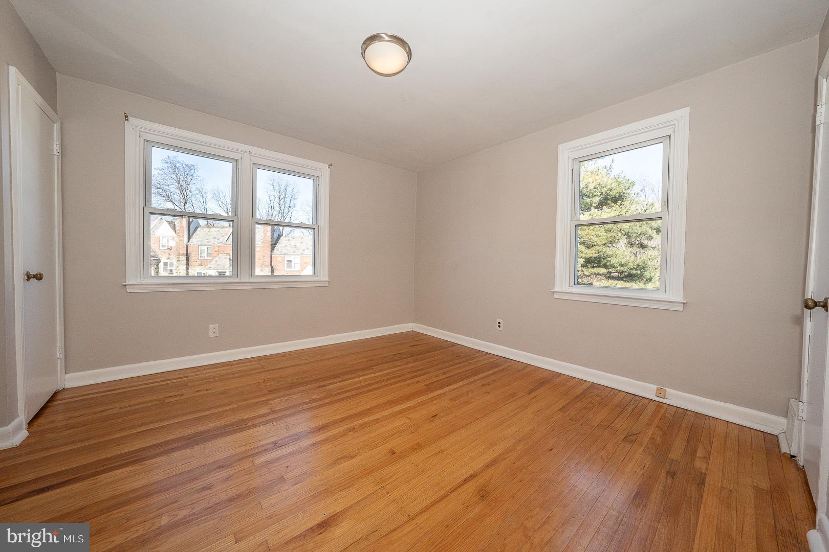 601 Briarcliff Road Upper Darby, PA 19082 - Photo 28 of 63 a view of an empty room with wooden floor and a window