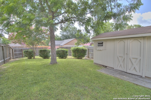 9902 Tezel Road San Antonio, TX 78254 - Photo 12 of 12 a view of a yard in front of a house with large tree