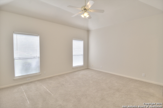 9902 Tezel Road San Antonio, TX 78254 - Photo 5 of 12 an empty room with windows and fan