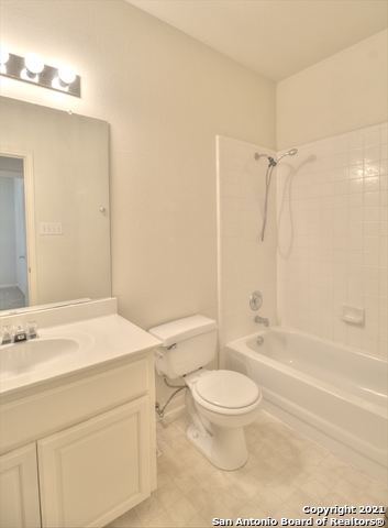 9902 Tezel Road San Antonio, TX 78254 - Photo 8 of 12 a bathroom with a sink a toilet and a bathtub