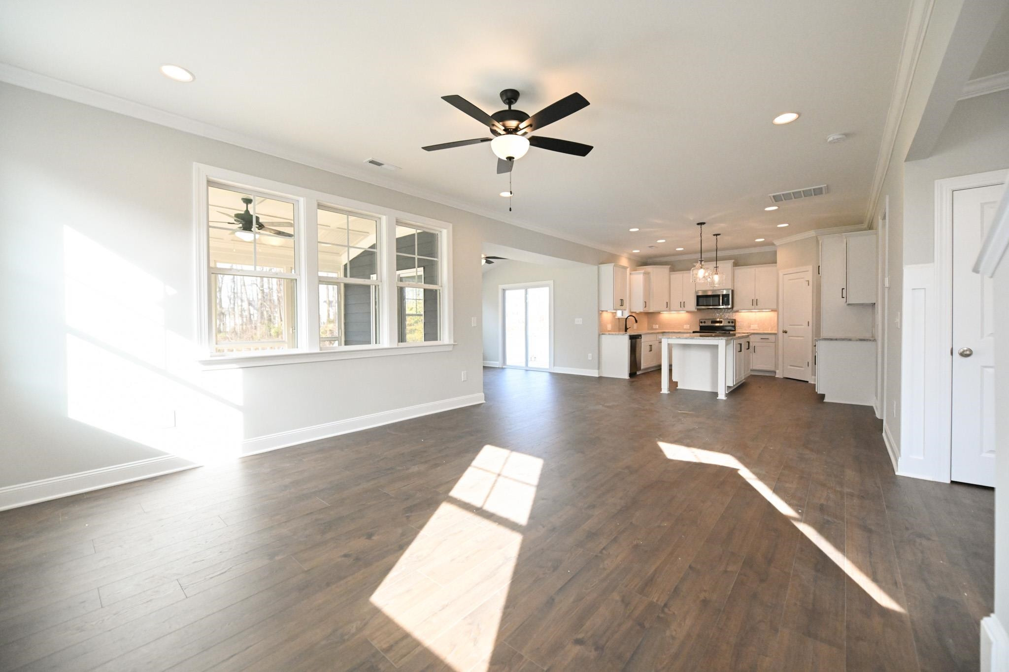110 Freewill Place Raleigh, NC 27603 - Photo 11 of 39 a view of a living room with wooden floor and a ceiling fan
