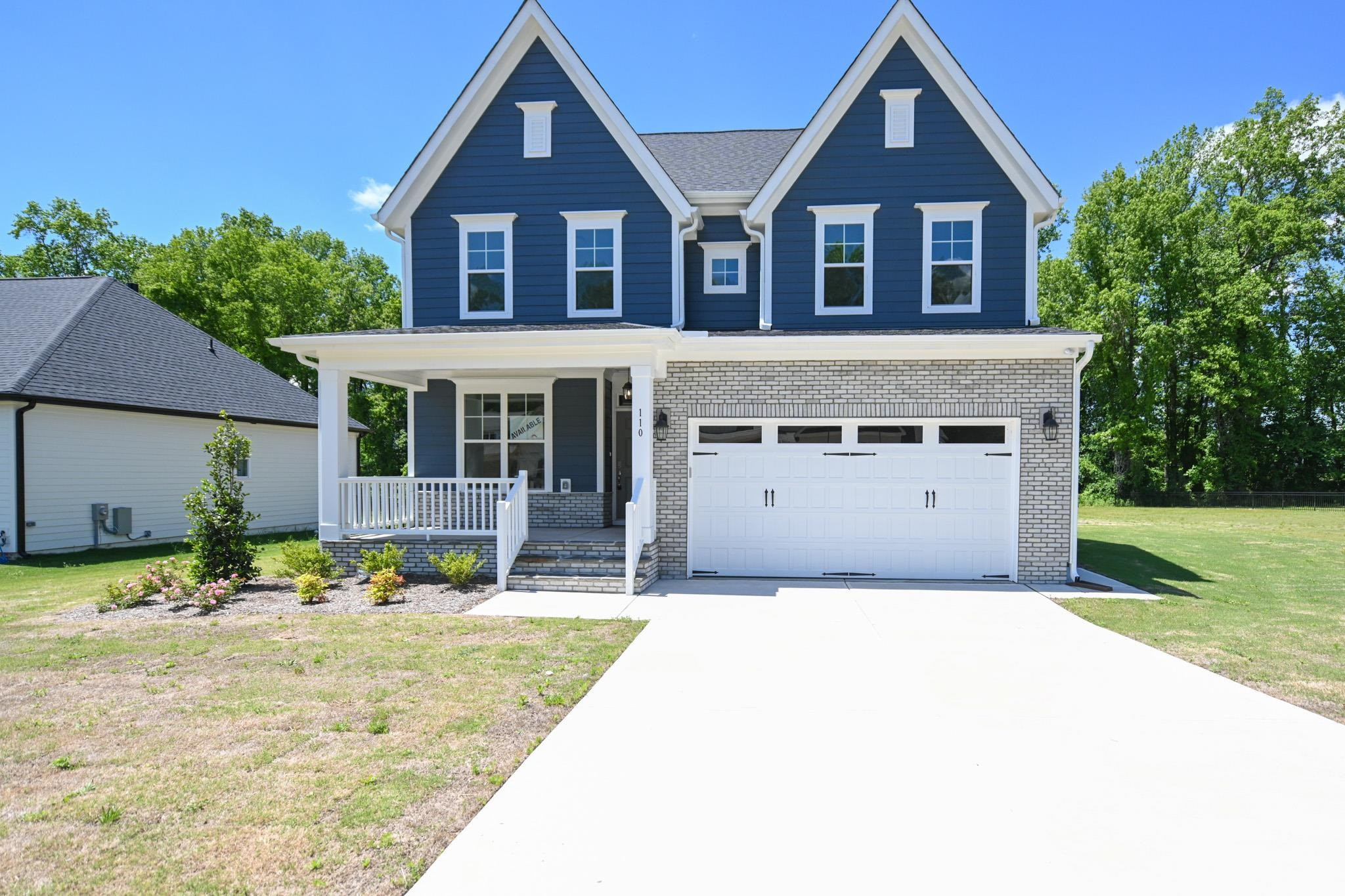 110 Freewill Place Raleigh, NC 27603 - Photo 2 of 39 a front view of a house with a yard and garage