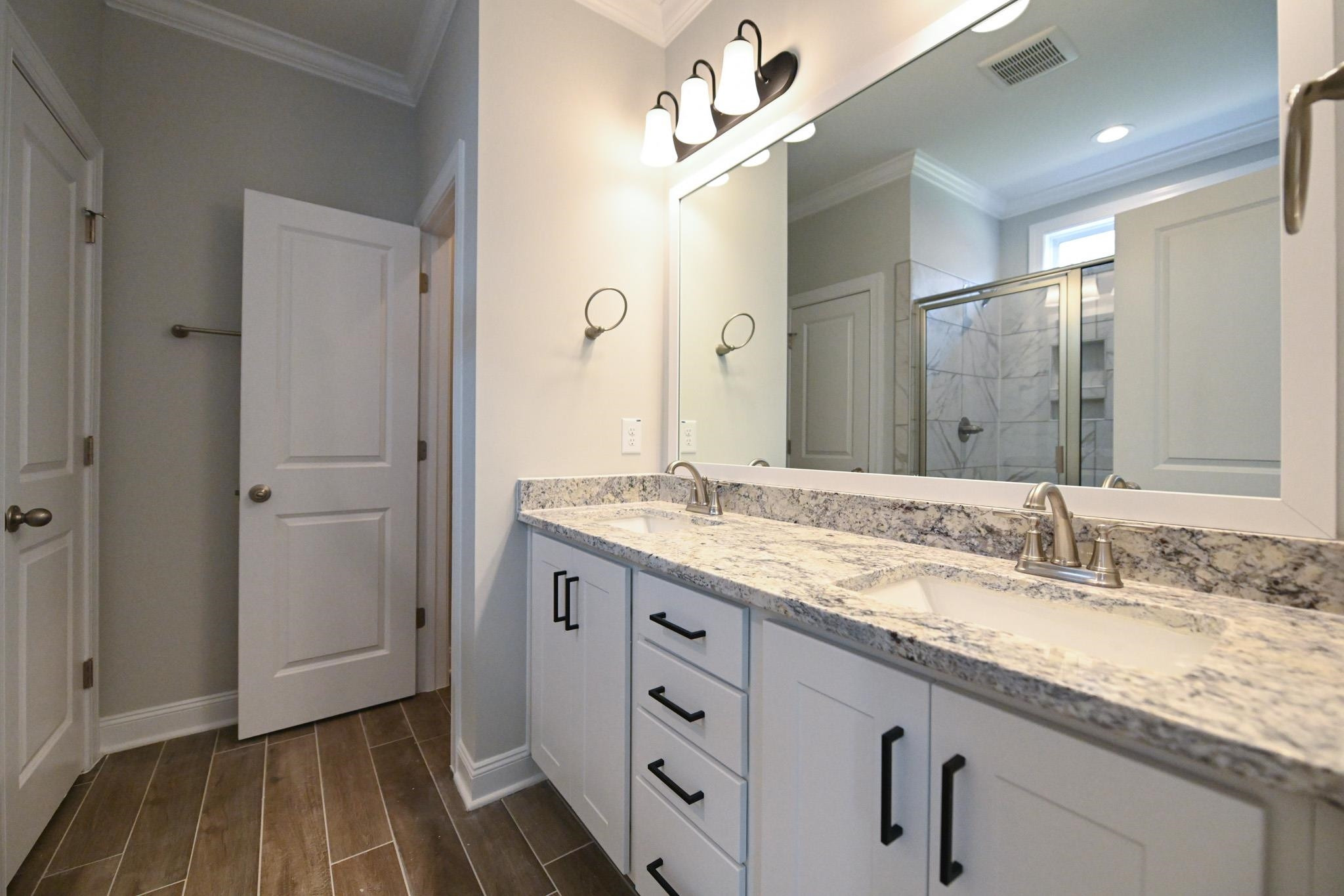 110 Freewill Place Raleigh, NC 27603 - Photo 25 of 39 a bathroom with a granite countertop sink a mirror and a shower
