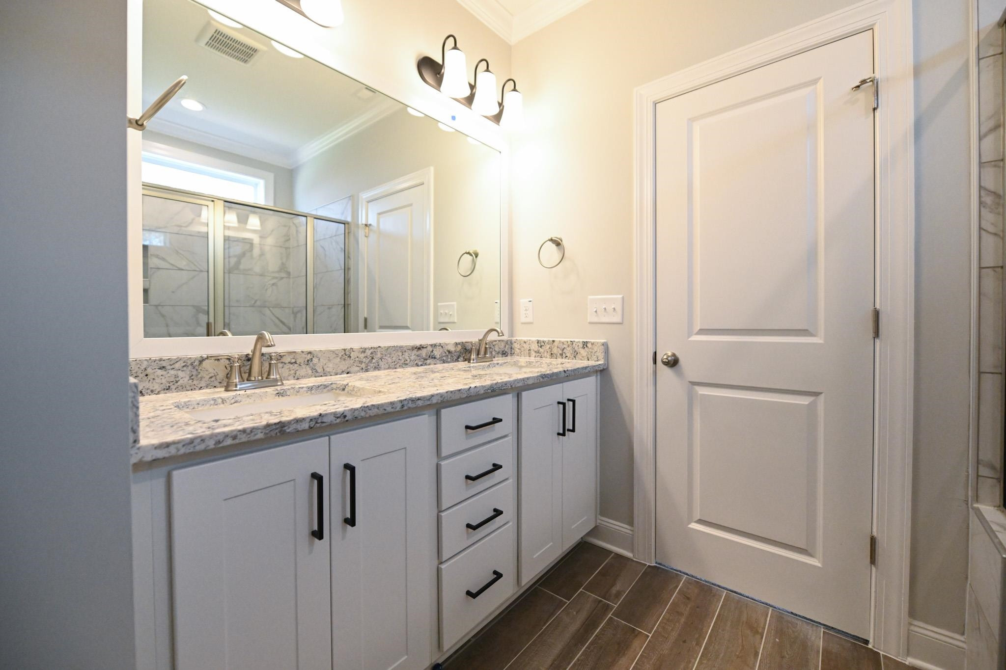 110 Freewill Place Raleigh, NC 27603 - Photo 26 of 39 a bathroom with a granite countertop sink a mirror and a