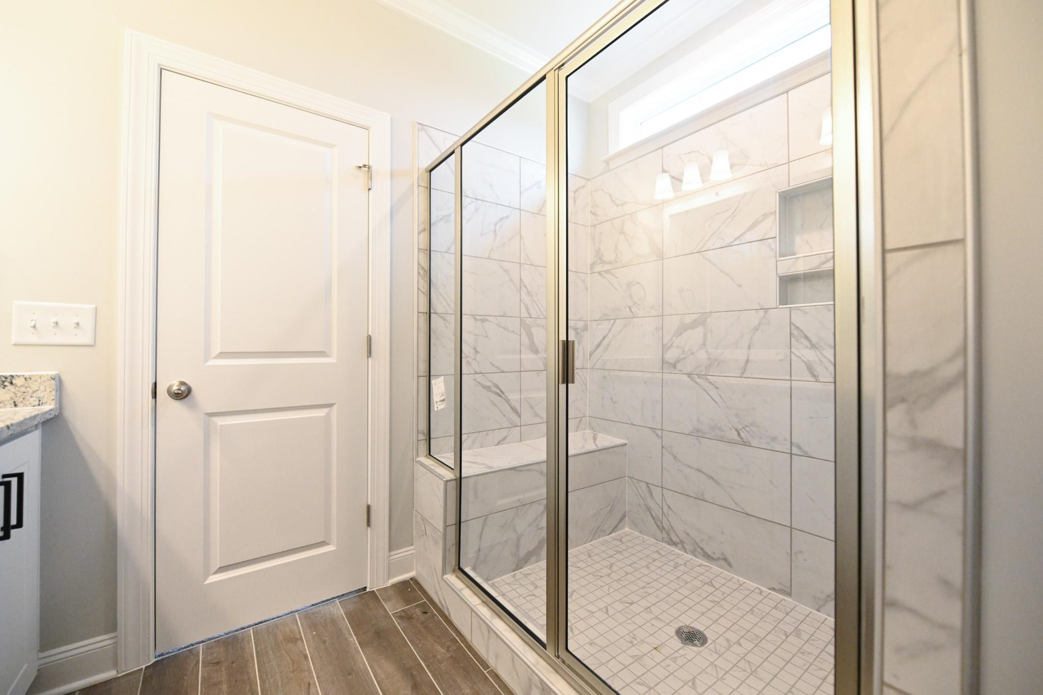 110 Freewill Place Raleigh, NC 27603 - Photo 27 of 39 a bathroom with a glass shower door