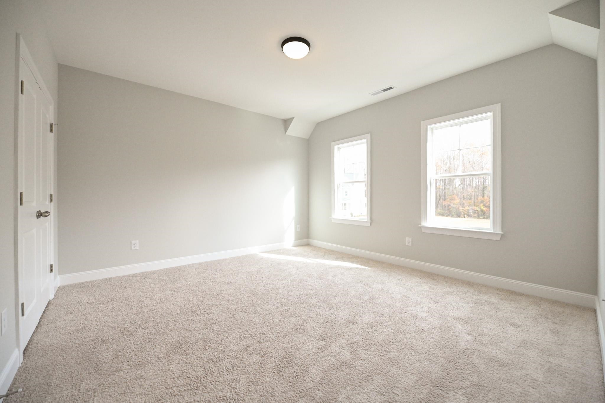 110 Freewill Place Raleigh, NC 27603 - Photo 28 of 39 an empty room with windows and closet